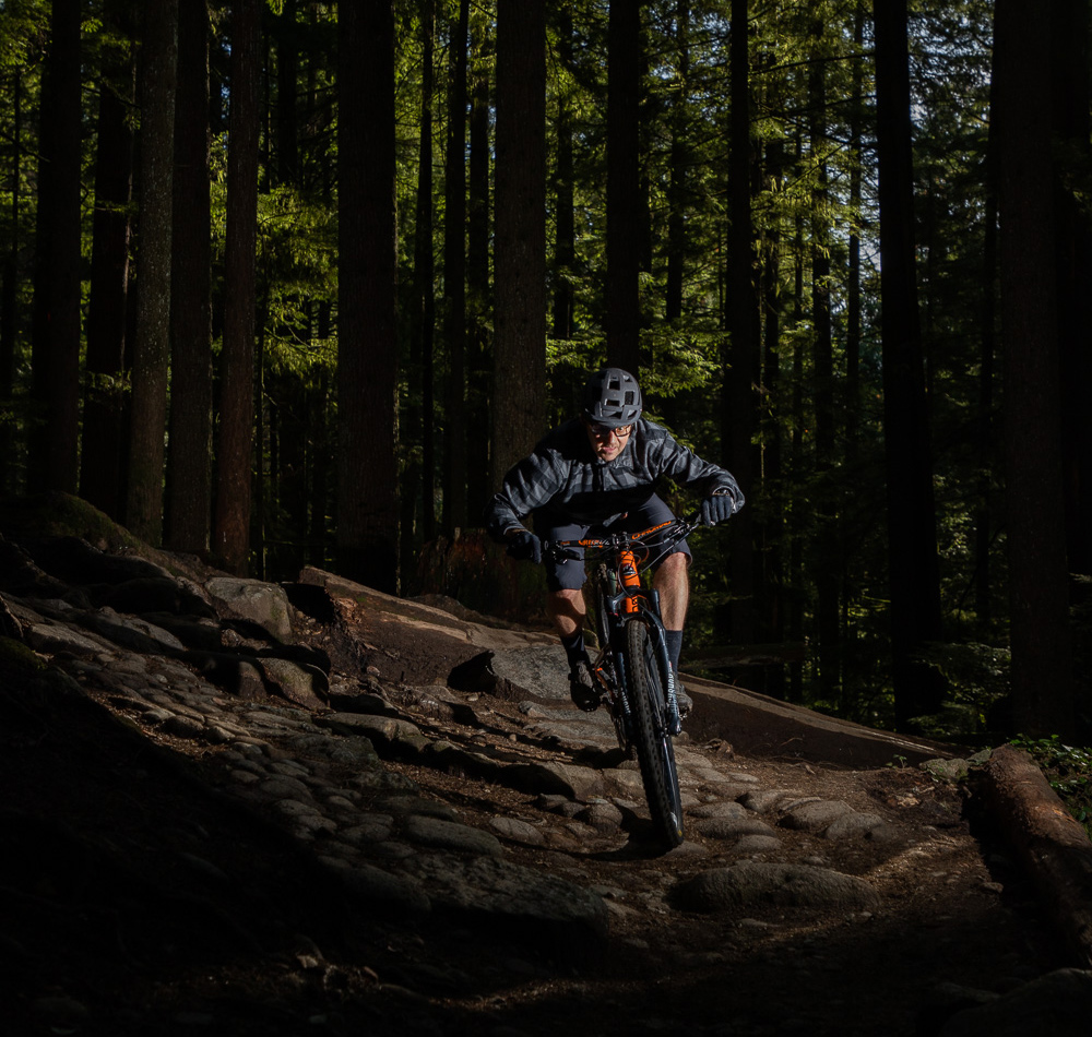Rich Scott riding his mountain bike on a rocky trail.