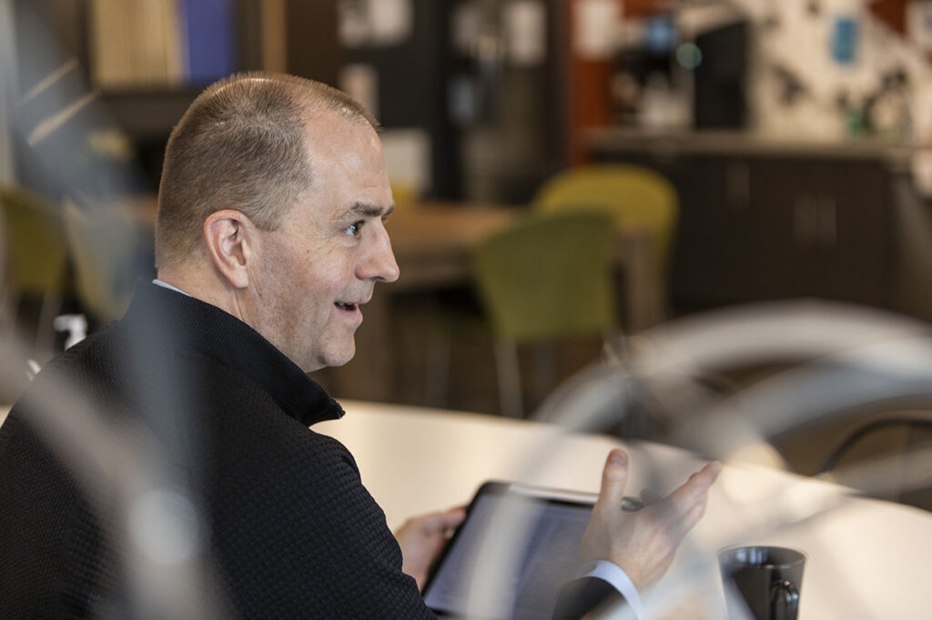 Rich Scott having a conversation while sitting at a table.