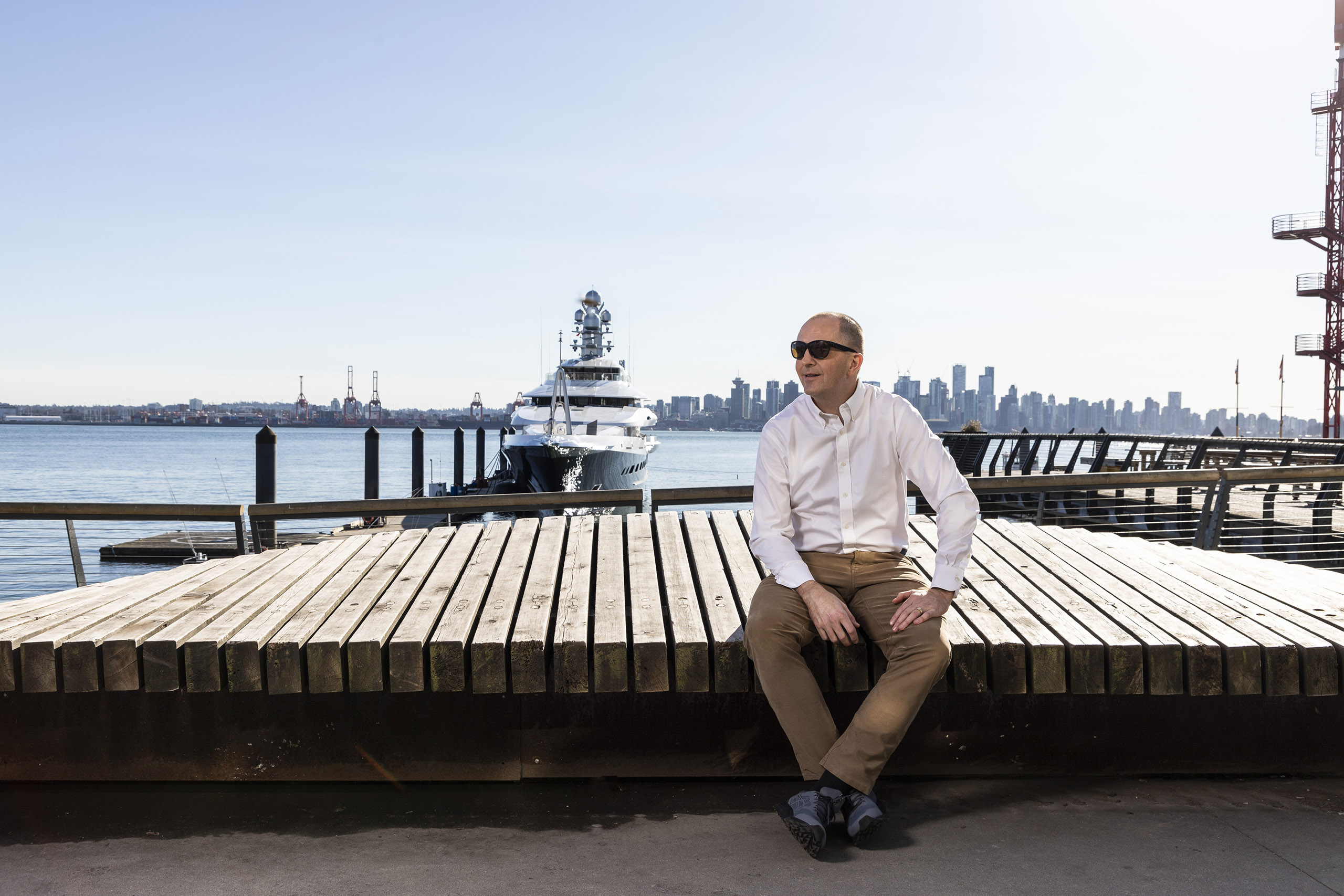 Rich Scott sitting at a pier in Vancouver.